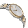 An image of a pre-owned wristwatch viewed from the side profile, opposite of the crown. The watch features a sleek design with a gold and silver two-tone band. The angle highlights the watch's face and bezel, showcasing its minimalist design. The shot is taken at a close distance, emphasizing the craftsmanship and materials.