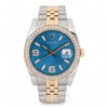 An image of a pre-owned unisex Rolex Datejust 36 18k Gold Steel Diamond Blue Wave Dial Watch 116243 taken from a front angle at a close distance. The watch features a two-tone metal bracelet with gold and steel links. Its bezel is adorned with diamonds, and the blue dial displays a date indicator at the 3 o'clock position. The hour markers and hands are gold-toned, complementing the overall luxurious design.