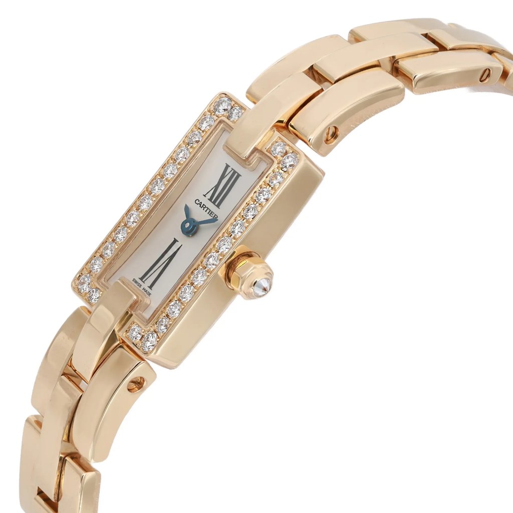An image of a pre-owned wristwatch showcasing a side profile view. The focus is on the watch's crown, which is prominently visible. The watch features a rectangular face adorned with a row of small, sparkling stones around the bezel. The metal bracelet is sleek and polished, complementing the elegant design.