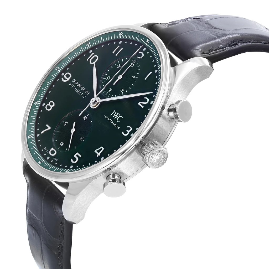 An image of an unworn IWC men's luxury wristwatch with a side profile view showcasing the crown. The watch features a round stainless steel case with a steel bezel and a green dial. It is fitted with a black leather band. The photograph is taken from a close distance, emphasizing the watch from a side angle to highlight the crown's details and the watch's contours.
