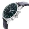 An image of an unworn IWC men's luxury wristwatch with a side profile view showcasing the crown. The watch features a round stainless steel case with a steel bezel and a green dial. It is fitted with a black leather band. The photograph is taken from a close distance, emphasizing the watch from a side angle to highlight the crown's details and the watch's contours.
