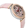 An image of a pre-owned wristwatch shown from a side profile view, opposite the crown. The watch features a pink leather strap and a round case with a rose gold and silver metallic finish. The dial is intricately designed with large, stylized numbers and visible internal mechanics. The shot is taken at a close angle, highlighting the watch's details and craftsmanship.