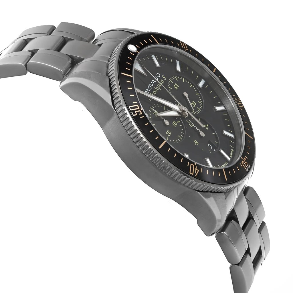An image of a pre-owned wristwatch viewed from a side profile angle, opposite the crown. The watch features a metal bracelet and a dark face with sub-dials. The angle highlights the watch's thickness and the detailing on the bezel, captured from a close distance.