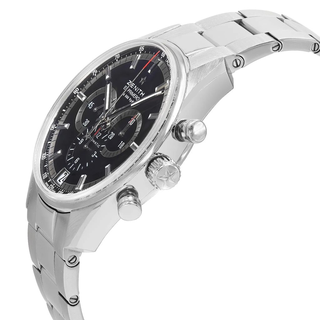 An image of a pre-owned wristwatch viewed from the side profile, showcasing the crown prominently. The watch features a metallic bracelet and a detailed black dial with subdials. The angle highlights the thickness of the case and the craftsmanship of the crown and pushers, captured at a close distance.