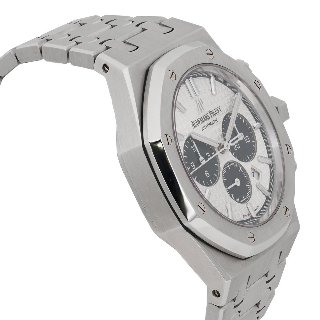 An image of a pre-owned men's Audemars Piguet wristwatch, captured from a slightly side angle. The watch face is prominently displayed, showcasing luminous hands and three subdials. The stainless steel bracelet and octagonal bezel are in focus, highlighting the watch's intricate design. The photo is taken at a close distance, emphasizing the fine details of the craftsmanship.