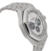 An image of a pre-owned men's Audemars Piguet wristwatch, captured from a slightly side angle. The watch face is prominently displayed, showcasing luminous hands and three subdials. The stainless steel bracelet and octagonal bezel are in focus, highlighting the watch's intricate design. The photo is taken at a close distance, emphasizing the fine details of the craftsmanship.
