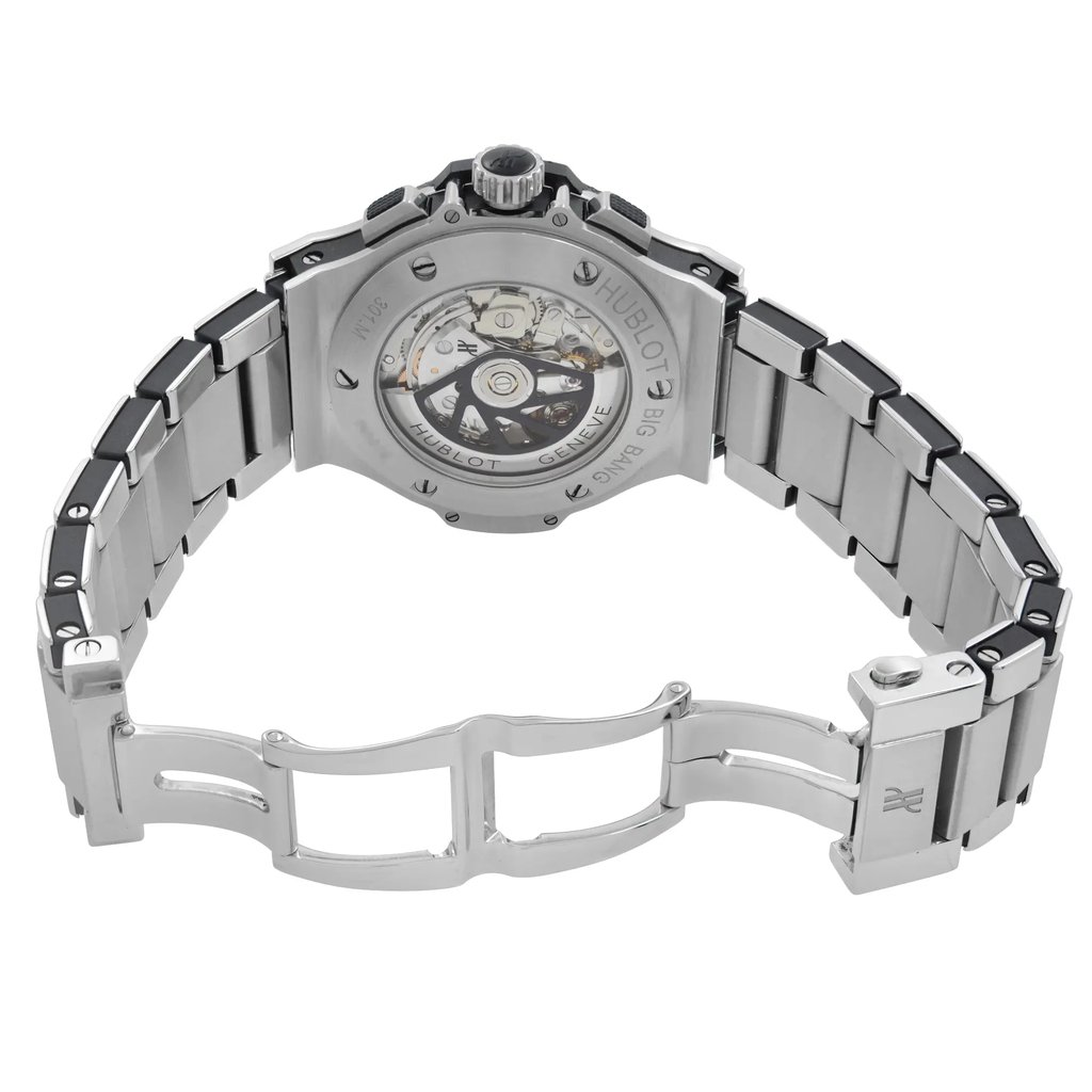 An image of a pre-owned wristwatch shown from the back view, displaying the open clasp and intricate workings. The watch is positioned at a slight angle, providing a clear view of the stainless steel bracelet and the transparent case back. The photo is taken from a close distance, highlighting the mechanical details and craftsmanship of the timepiece.