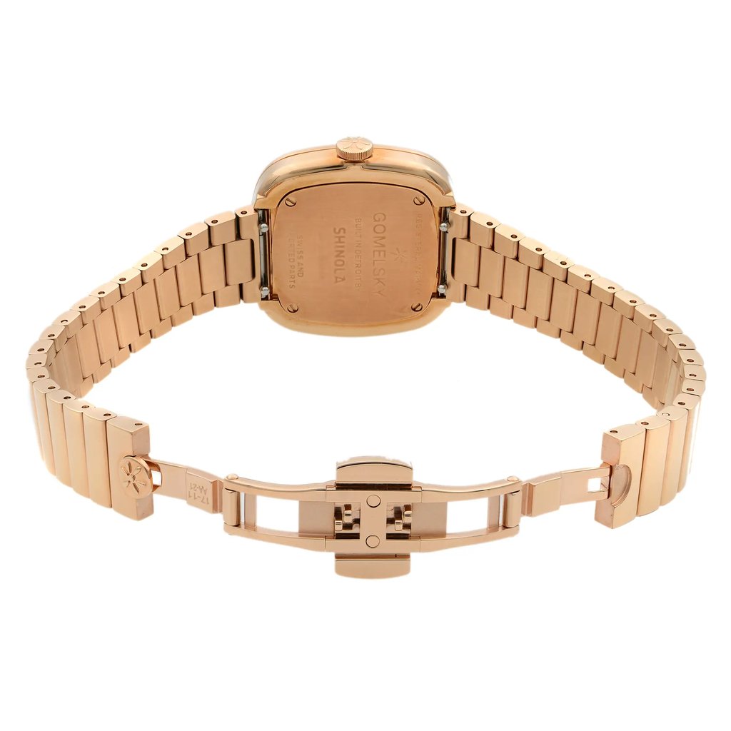 An image of an unworn wristwatch taken from the back view, showing the open clasp. The watch is positioned upright with the bracelet laid out horizontally. The angle captures the case back and the full length of the band from a straight-on perspective, highlighting the detailed engravings and the clasp mechanism. The distance is close enough to clearly display the construction and materials.