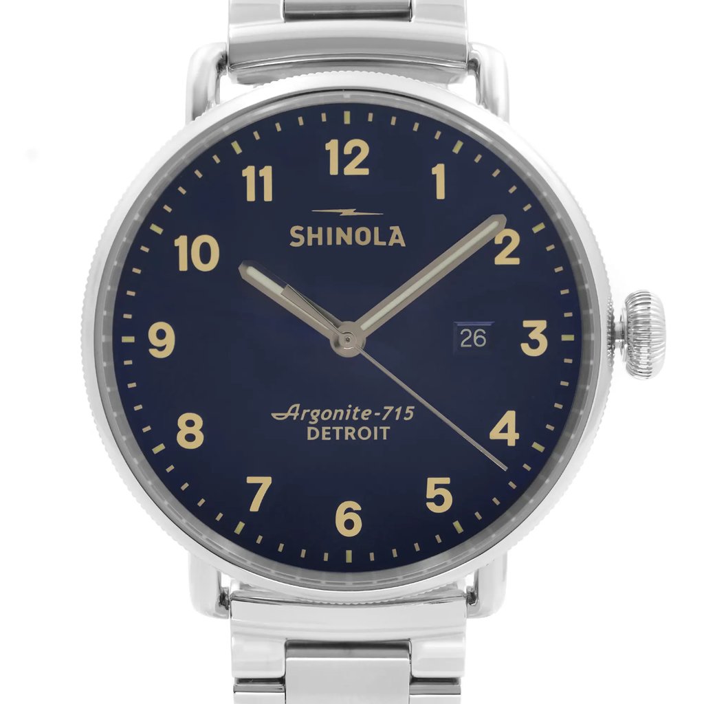 An image of a wristwatch taken from a front close-up angle, showcasing the watch face prominently. The watch features a dark blue dial with white numerals and hands. The date is displayed at the 3 o'clock position. The silver casing and part of the metal strap are visible, indicating its display model condition.