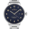 An image of a wristwatch taken from a front close-up angle, showcasing the watch face prominently. The watch features a dark blue dial with white numerals and hands. The date is displayed at the 3 o'clock position. The silver casing and part of the metal strap are visible, indicating its display model condition.