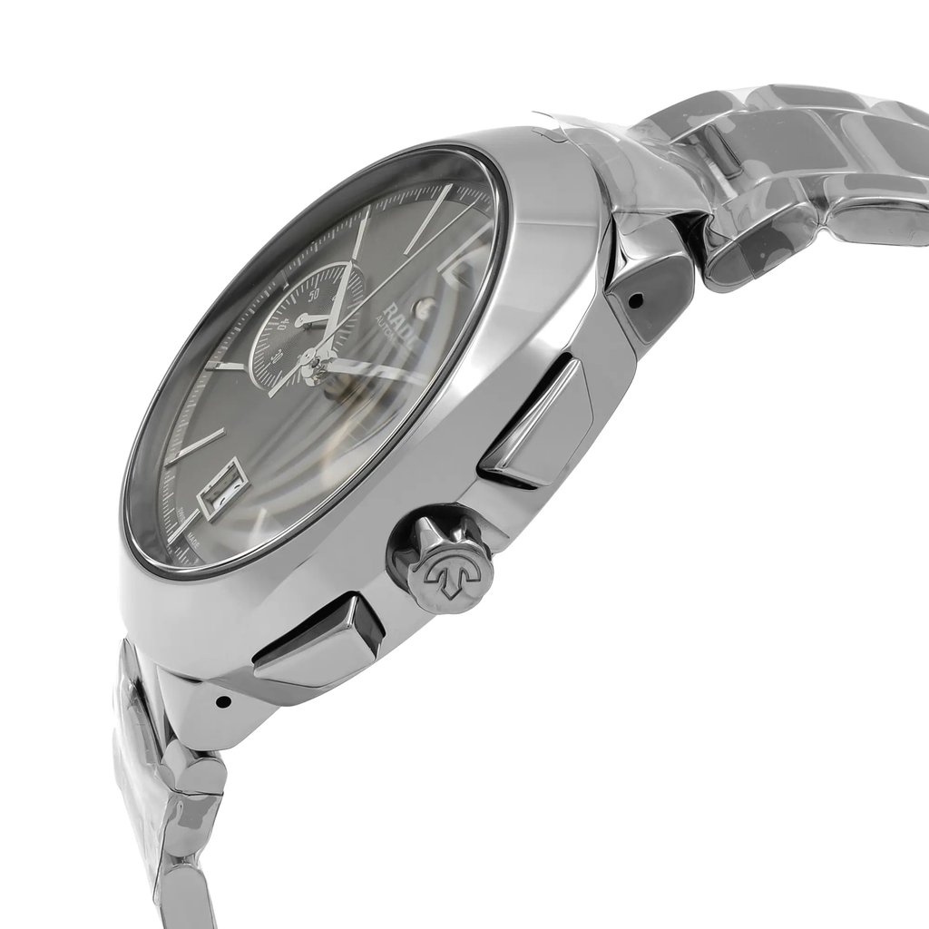 An image of a new wristwatch shown from a side profile view, highlighting the crown. The angle captures the sleek metallic finish and detailed craftsmanship of the watch's case and bracelet. The close-up perspective emphasizes the design elements, including the watch face and crown.
