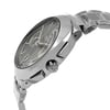 An image of a new wristwatch shown from a side profile view, highlighting the crown. The angle captures the sleek metallic finish and detailed craftsmanship of the watch's case and bracelet. The close-up perspective emphasizes the design elements, including the watch face and crown.