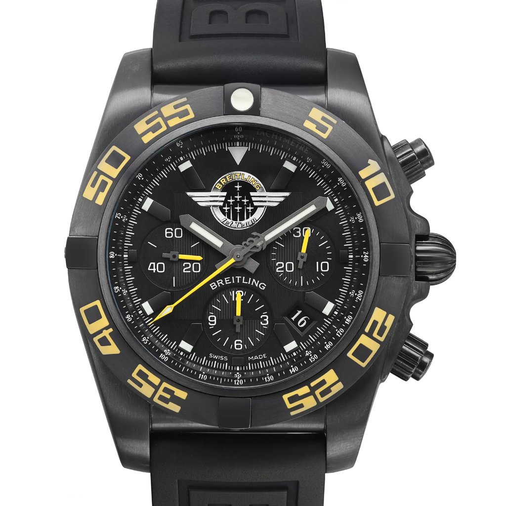 An image of a pre-owned Breitling men's pilot/aviator wristwatch with a close-up frontal view of the round black dial and bezel. The watch features a rubber band, black brushed stainless steel case, and displays 12-hour dial indices with arrow markers and a second hand. The black bezel has yellow numerals and the black dial includes the Breitling logo jet team edition. There are micro insignificant dings on the bezel and case back, with tiny scratches on the case that are barely visible. The shot is taken from a direct, centered angle and fills the frame, showcasing the watch's excellent condition.