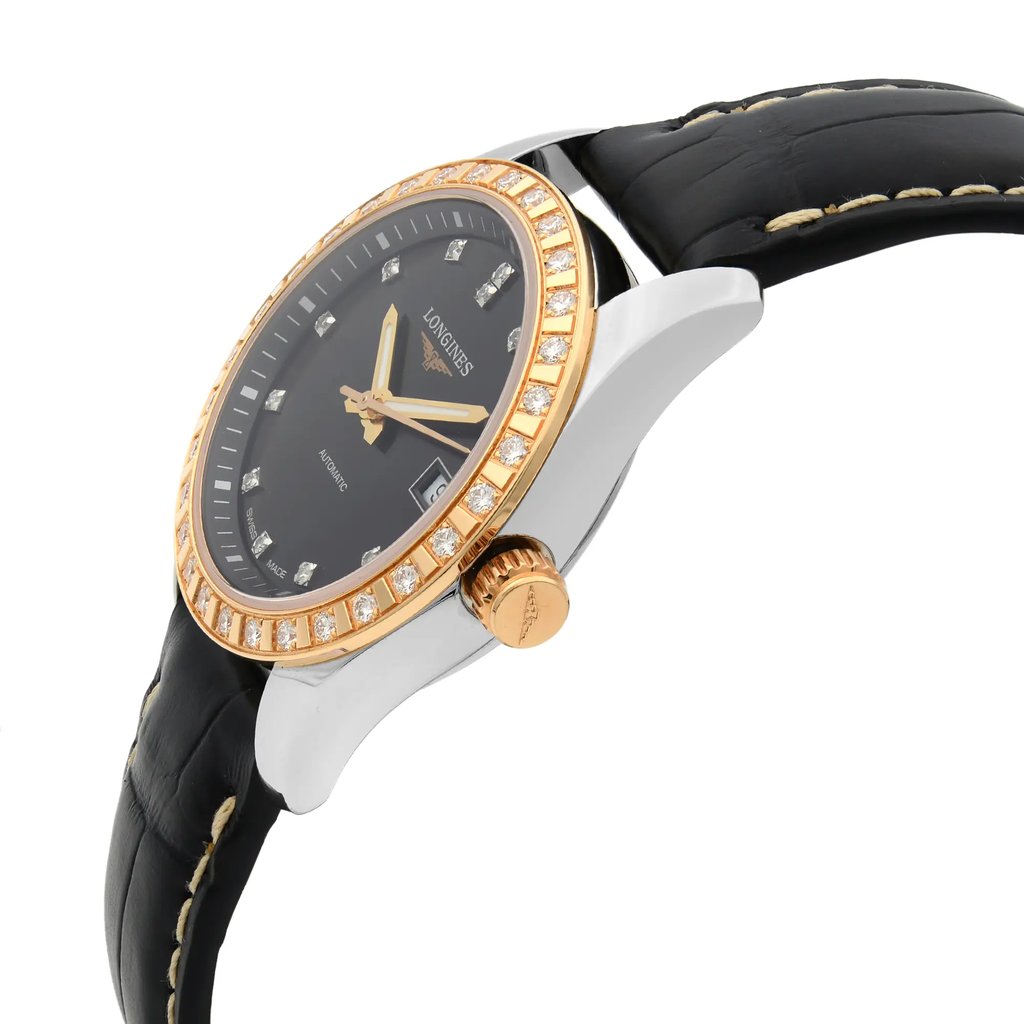 An image of a wristwatch in a side profile view, showcasing the crown prominently. The watch has a black dial with gold hands and hour markers, encircled by a diamond-studded bezel. The casing is silver with a gold crown. The black leather strap, with visible stitching, is partially shown. The photo is taken at a close distance, highlighting the watch's luxurious details.
