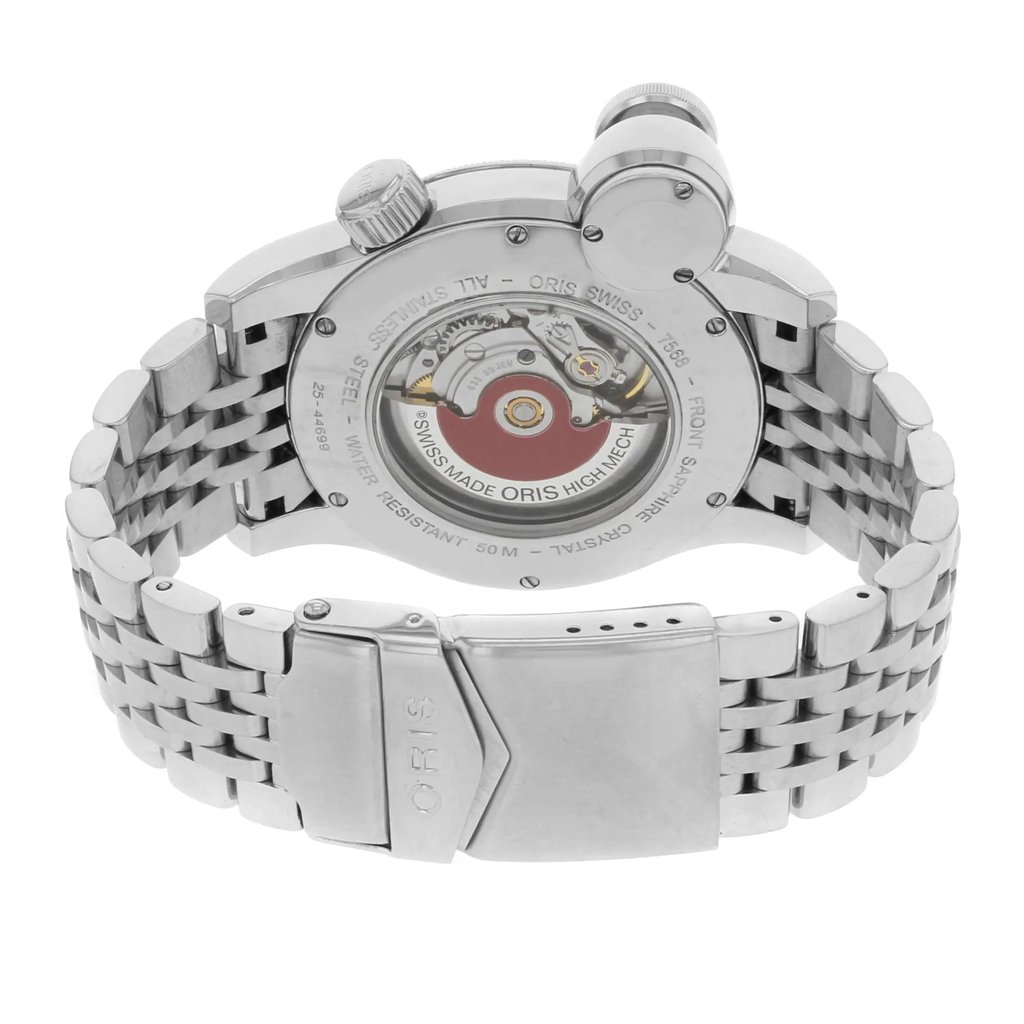 An image of a pre-owned wristwatch shown from the back view, highlighting the close clasp and intricate metallic design. The watch face is not visible, but the inner mechanical components are exposed through the transparent case back. The band features a polished, linked metal bracelet, and the brand name is engraved on the clasp. The angle is slightly elevated, providing a clear and detailed view of the watch's craftsmanship.