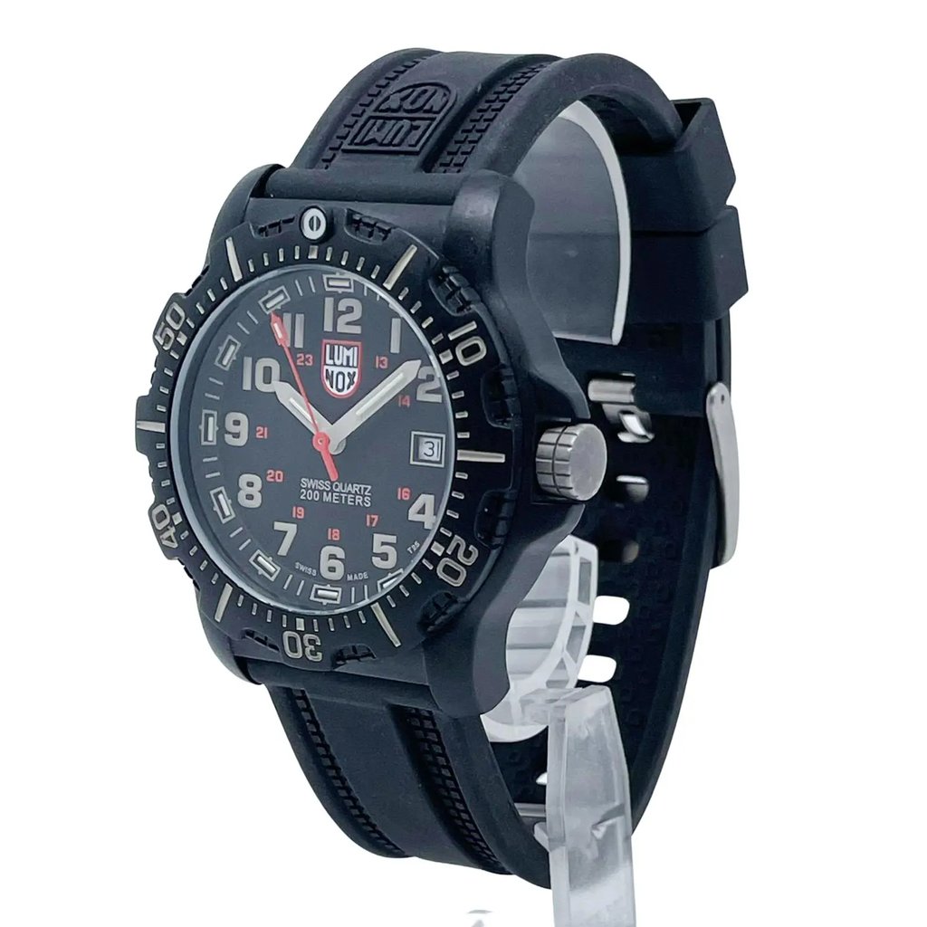 An image of a Wristwatch by Luminox. This Pre Owned item is designed for Men, featuring a Diver,Military style. It has a Quartz movement and an Analog display with a Black dial color. The indices include 12-Hour Dial,Arabic Numerals,Easy to Read/Large Numerals. The band is made of Rubber and the case is made of Carbon. The watch has a Round shape with a case size of 44 mm and a case thickness of 14 mm.