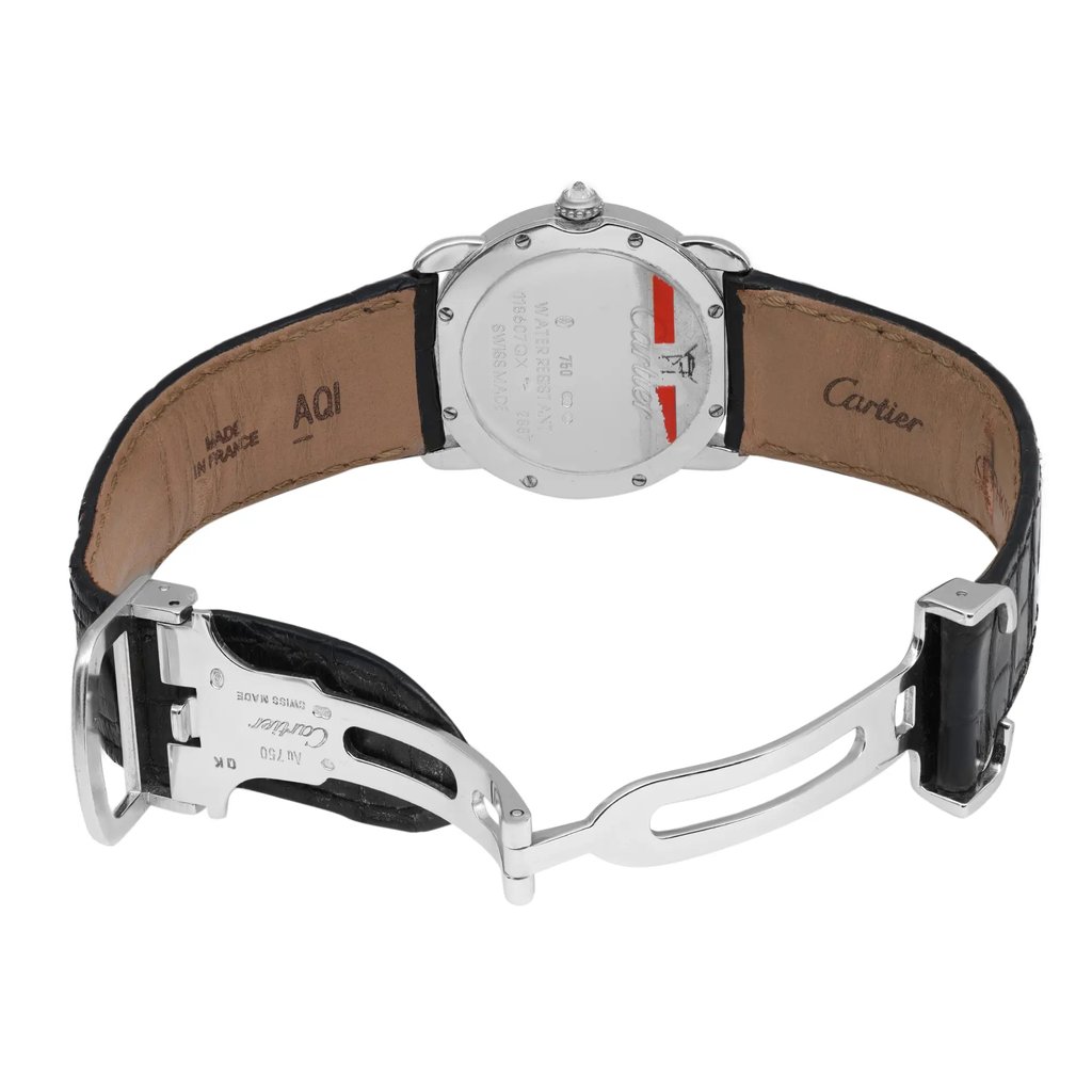 An image of a pre-owned wristwatch viewed from the back, showcasing the open clasp. The watch is positioned upright, with the case back facing the viewer, allowing a clear view of the engraved details. The angle highlights the inner leather strap and metallic clasp components, captured from a moderate distance to encompass the full length of the strap.