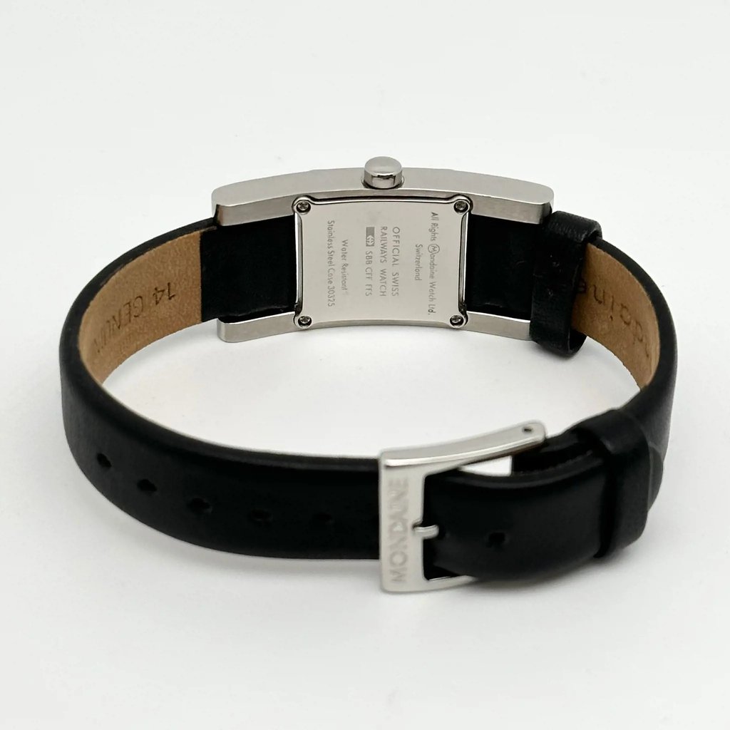 An image of a Wristwatch by Mondaine. This Pre Owned item is designed for Women, featuring a Casual style. It has a Quartz movement and an Analog display with a White dial color. The indices include 12-Hour Dial,Non-Numeric Hour Marks,Stick Indexes. The band is made of Leather and the case is made of Stainless Steel. The watch has a Rectangle shape with a case size of 20 mm and a case thickness of 7 mm.