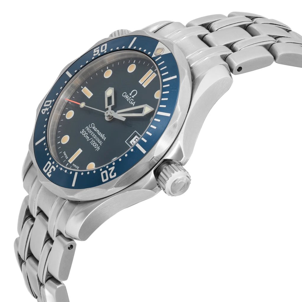 An image of a pre-owned wristwatch viewed from the side profile, showcasing the crown prominently. The watch features a silver metal bracelet and a blue bezel with white markings. The angle captures the watch face slightly tilted, highlighting the hands and indices against the dark dial. The image is taken at a close distance, offering a detailed view of the watch's design and craftsmanship.