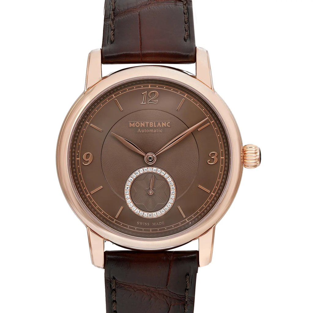 An image of a front close-up view of a Montblanc women's luxury wristwatch. The watch features a round rose gold case with a brown dial, Arabic numerals, and stick indexes for the 12-hour display. A small seconds subdial is encircled by a ring of crystals. It has a rose gold bezel and a brown leather band. The watch is positioned straight on and occupies the majority of the frame, showcasing its excellent condition and elegant design.