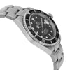 An image of a pre-owned wristwatch captured from a side profile view, opposite the crown. The angle highlights the watch's black dial with white markers and its stainless steel bracelet. The photo is taken from a medium distance, showcasing the detailed design of the bezel and links.