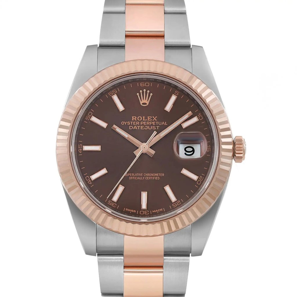 An image of a pre-owned men's Rolex wristwatch taken from a front-facing angle. The watch features a brown dial with luminous hands and a date indicator. The bezel and center links of the bracelet are in rose gold, while the outer links are in stainless steel. The photograph is taken at a close distance, highlighting the intricate details of the watch face and bracelet.