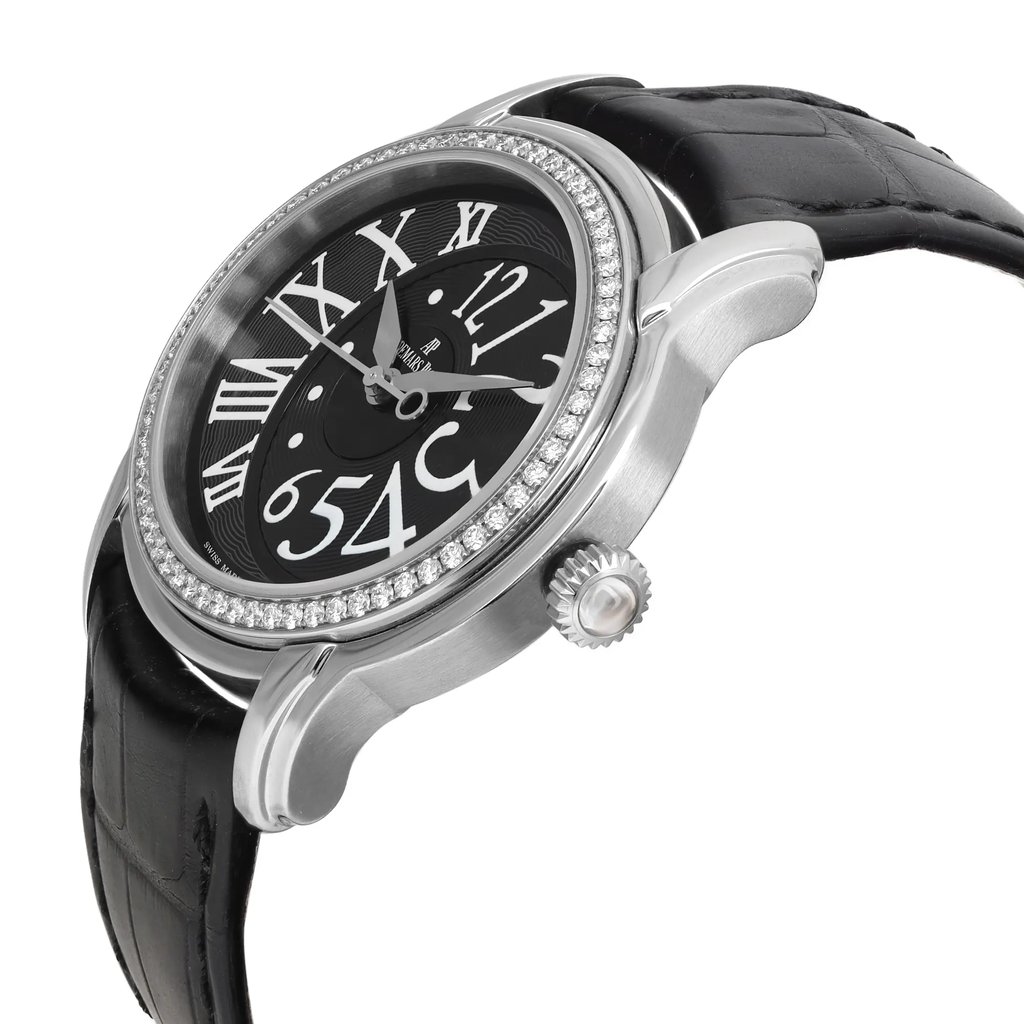An image of a pre-owned wristwatch viewed from the side profile, showcasing the crown prominently. The watch features a black leather strap and a round face with a silver bezel adorned with small stones. The dial is black with large, stylized white numerals, and the watch hands are visible. The angle emphasizes the watch's thickness and detailed design, captured at a close distance.