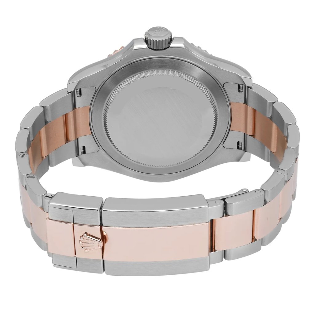 An image of a pre-owned wristwatch showing the back view with a closed clasp. The watch features a two-tone metal band, combining silver and rose gold links. The image is taken from a close distance, highlighting the brushed metal finish on the case back and the intricate design of the clasp.