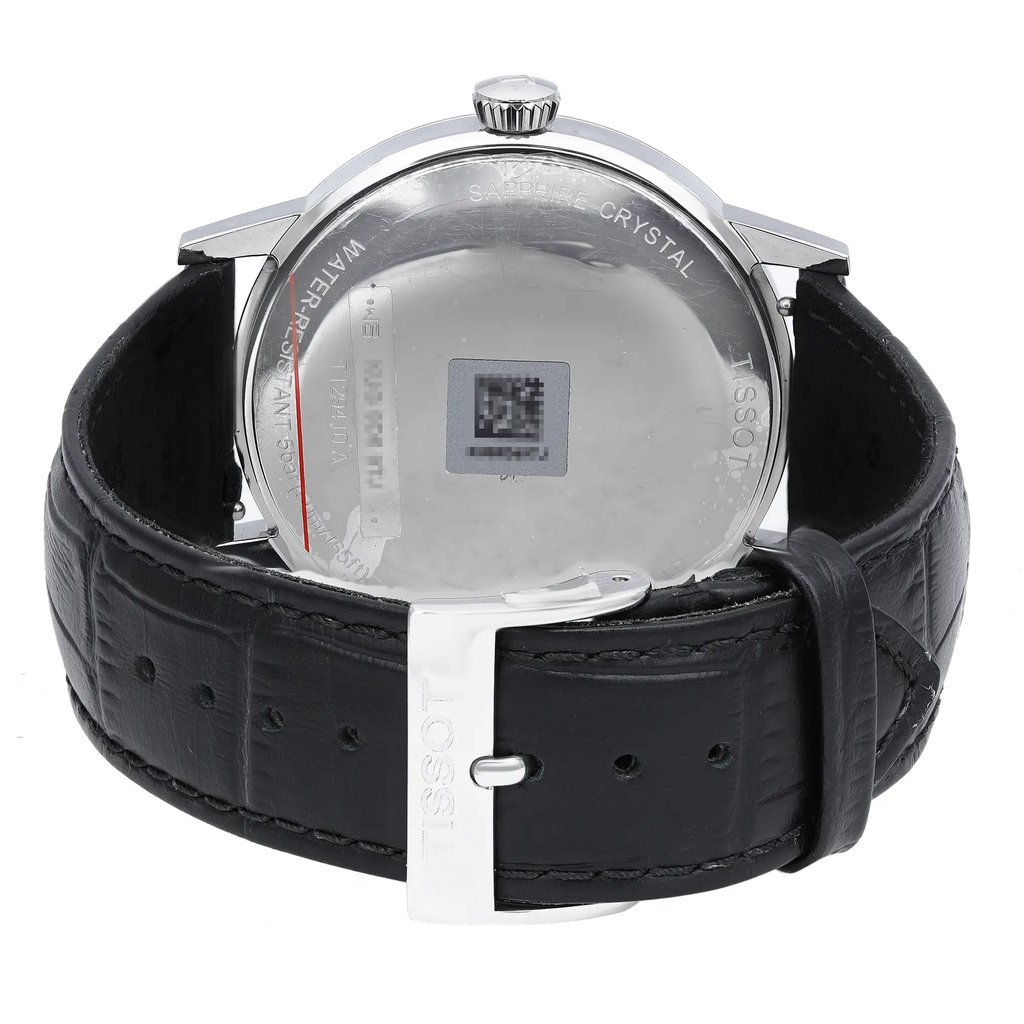 An image of a Wristwatch by Tissot. This New With Defects item is designed for Men, featuring a Dress/Formal style. It has a Quartz movement and an Analog display with a Black dial color. The indices include 12-Hour Dial,Roman Numerals. The band is made of Leather and the case is made of Stainless Steel. The watch has a Round shape with a case size of 42 mm and a case thickness of 9 mm.