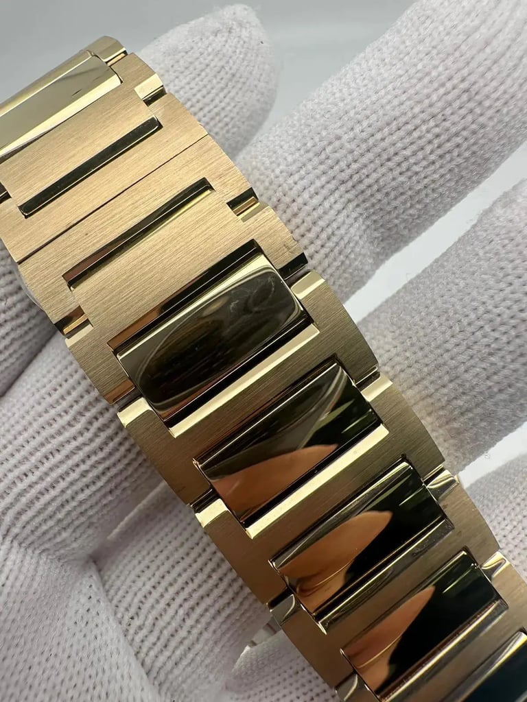 An image of a Wristwatch by Movado. This Pre Owned item is designed for Women, featuring a Casual style. It has a Quartz movement and an Analog display with a Gold dial color. The indices include 12-Hour Dial,No Hour Marks. The band is made of Stainless Steel and the case is made of Stainless Steel. The watch has a Round shape with a case size of 34 mm and a case thickness of 8 mm.