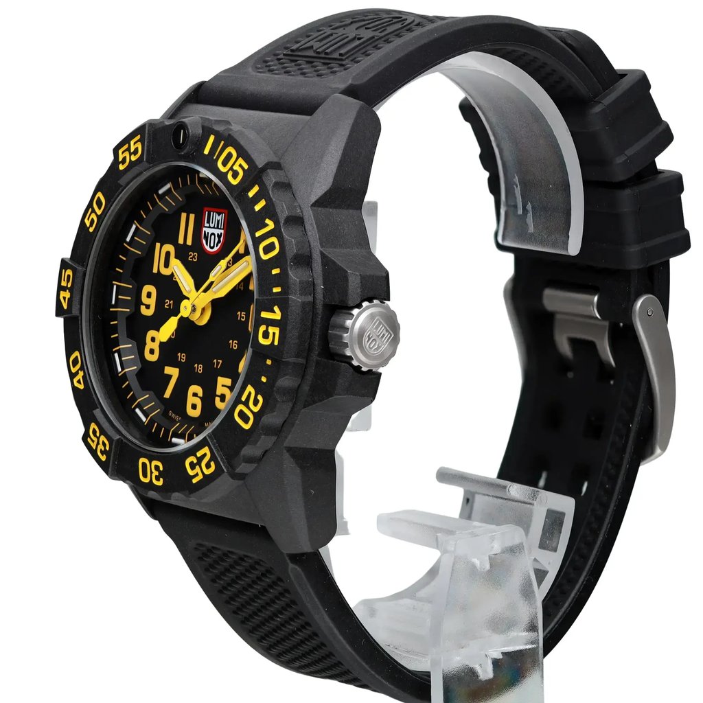 An image of a Wristwatch by Luminox. This Display Model item is designed for Men, featuring a Casual,Diver,Military style. It has a Quartz movement and an Analog display with a Black dial color. The indices include 12-Hour Dial,Arabic Numerals,Easy to Read/Large Numerals. The band is made of Rubber and the case is made of Carbon. The watch has a Round shape with a case size of 45 mm and a case thickness of 14 mm.
