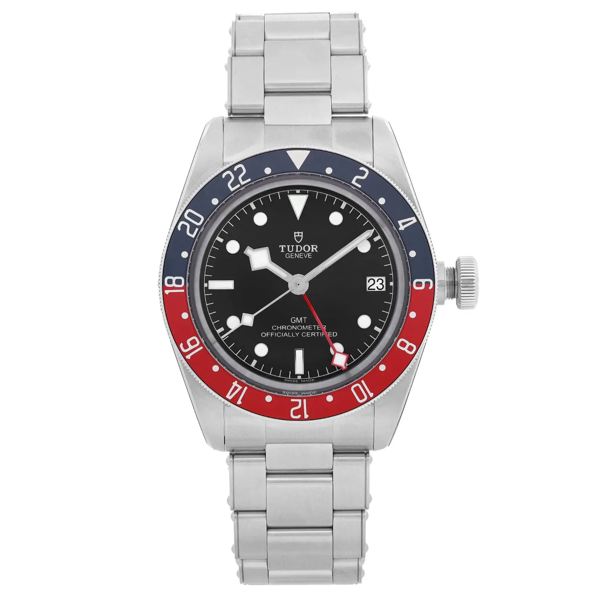 An image of a men's luxury sport wristwatch by TUDOR, shown from a front full frontal view. The unworn watch features a round black dial with non-numeric hour marks and round indexes, complemented by luminous hands and a seconds hand. The bezel is colored blue and red, and the watch includes features such as a date indicator and GMT. The band and case are made of stainless steel. The photograph captures the watch in a straightforward manner, highlighting its design and details.