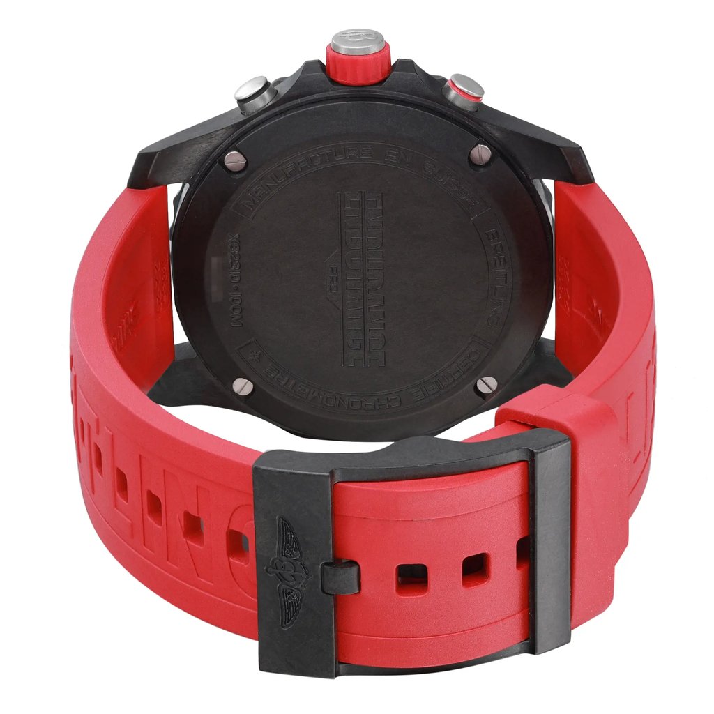 An image of a Breitling men's wristwatch, showcasing the back view with a closed clasp. The watch, portrayed as a display model, has a black Breitlight case with a caseback and a round shape. Attached is a red rubber band featuring a buckle closure. The photograph is taken from a top-down angle, providing a clear and close-up view of the watch's structure and design details. Can have minor blemishes on the watch during handling and shipping. 