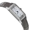 An image of a pre-owned wristwatch shown from the side profile view, opposite the crown. The watch has a rectangular face with a silver casing and a leather strap. The angle highlights the watch's sleek design, capturing it from a close distance to emphasize the details of the face and strap texture.