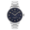 An image of a wristwatch shown from a front full frontal view. The watch features a silver metal strap and a dark blue dial with beige numerals and hands. The brand name is visible on the face, along with the model details. The watch is positioned centrally in the image, displaying its condition as a display model.