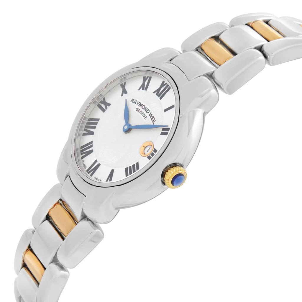 An image of a luxury women's wristwatch, viewed from the side profile with the crown prominently showing. The watch is unworn and features a round shape with a silver dial and gray bezel. The band and case are made of stainless steel. The watch includes a date indicator, and the crown is accented in gold and blue. The angle highlights the elegant design and craftsmanship of the Raymond Weil brand.