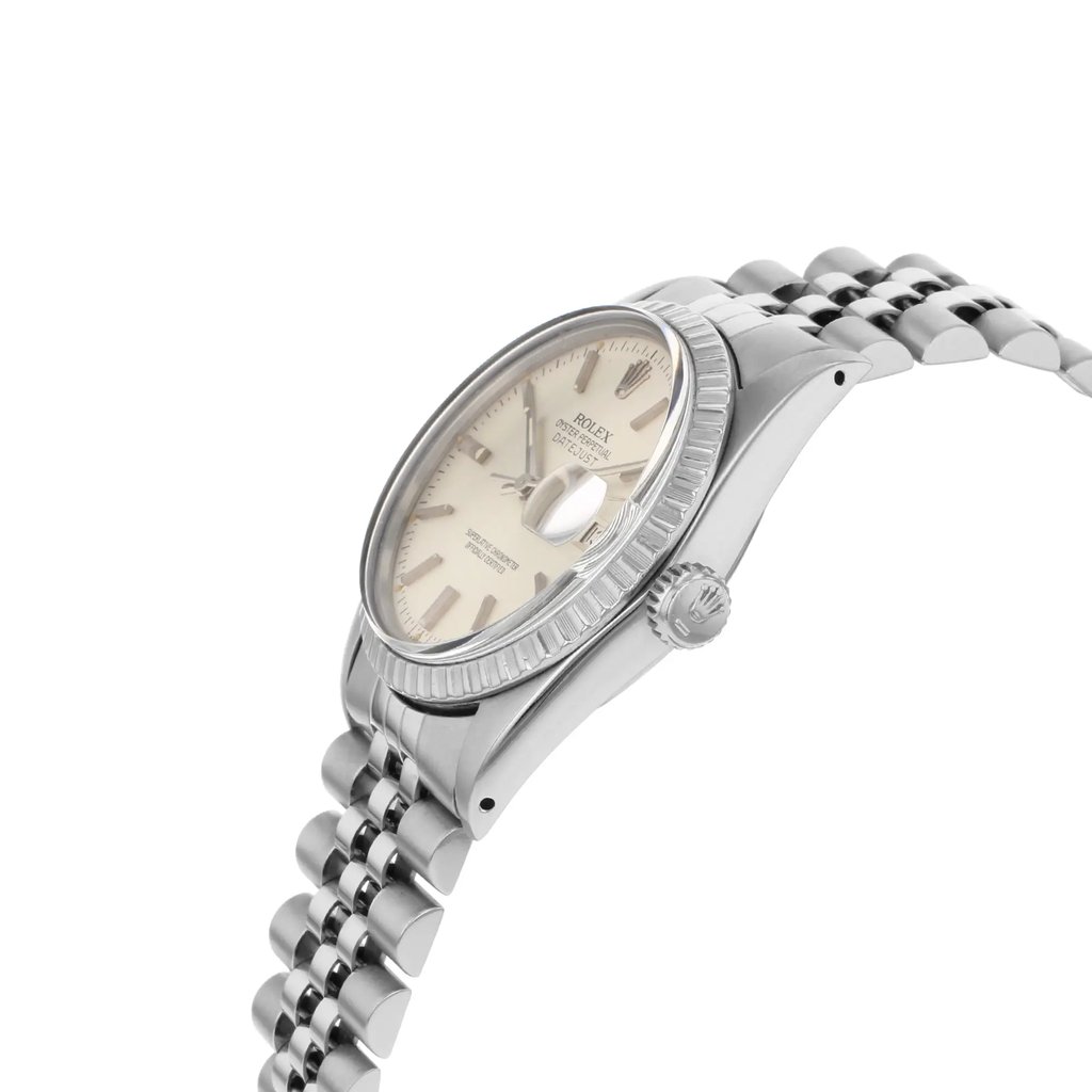 An image of a pre-owned wristwatch viewed from a side profile angle, highlighting the crown. The watch has a stainless steel case and a jubilee bracelet, with a light-colored dial. The image captures the watch from a slightly elevated angle, focusing on the details of the bezel and the crown, showcasing its elegant design.