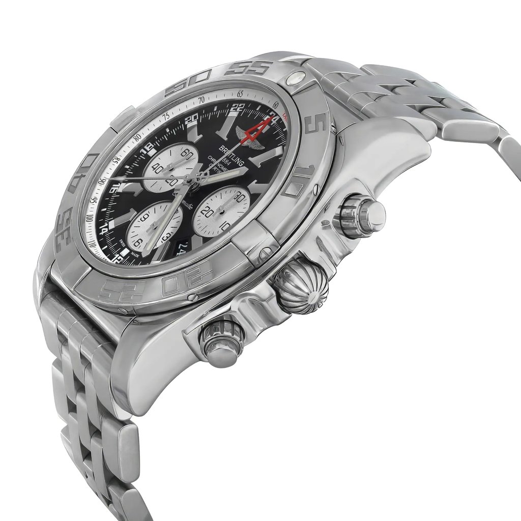 An image of a pre-owned Breitling men's wristwatch in a luxury style, captured from a side profile angle with the crown visible. The watch features a round stainless steel case and band, a gray bezel, and a black dial with luminous hands, a date indicator, GMT, and a small seconds subdial. The image is taken from a close highlighting light signs of wear such as minor scratches. The perspective is slightly tilted, showcasing the watch's design and features.