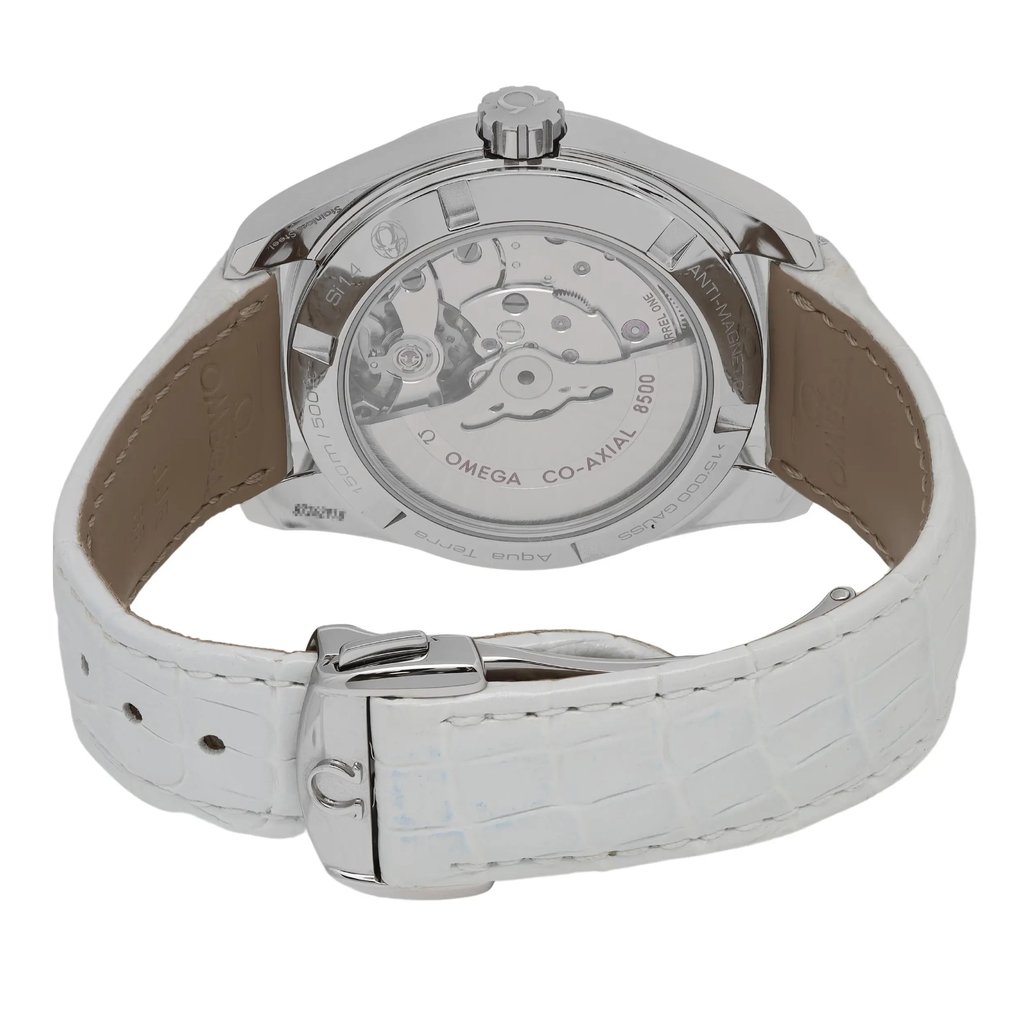 The image presents a back view of a women's OMEGA wristwatch, positioned upright at a slight angle to emphasize the transparent case back and visible mechanical movement. The white leather strap is prominently displayed in the foreground. There are a few minor blue marks near the buckle, possibly from storage, as visible in the picture. The image, taken from a close distance, captures the detailed features of the watch, including the date indicator and luminous hands.