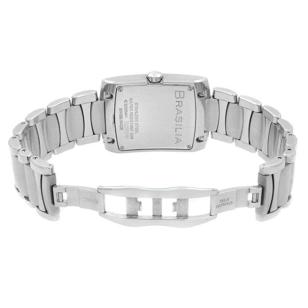 An image of a pre-owned wristwatch shown from the back view, with an open clasp. The watch features a stainless steel band and rectangular case, with visible engravings including "BRASILIA" and details about its water resistance and Swiss make. The angle captures the watch straight on from a medium distance, highlighting the open clasp and the links of the band.