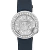 An image of a pre-owned women's Cartier wristwatch viewed from a straight-on angle, showcasing its elegant design. The watch features a round silver-tone face with Roman numeral hour markers and a diamond-encrusted bezel. The strap is a dark blue color, and the image is captured at a close distance to highlight the intricate details and craftsmanship.