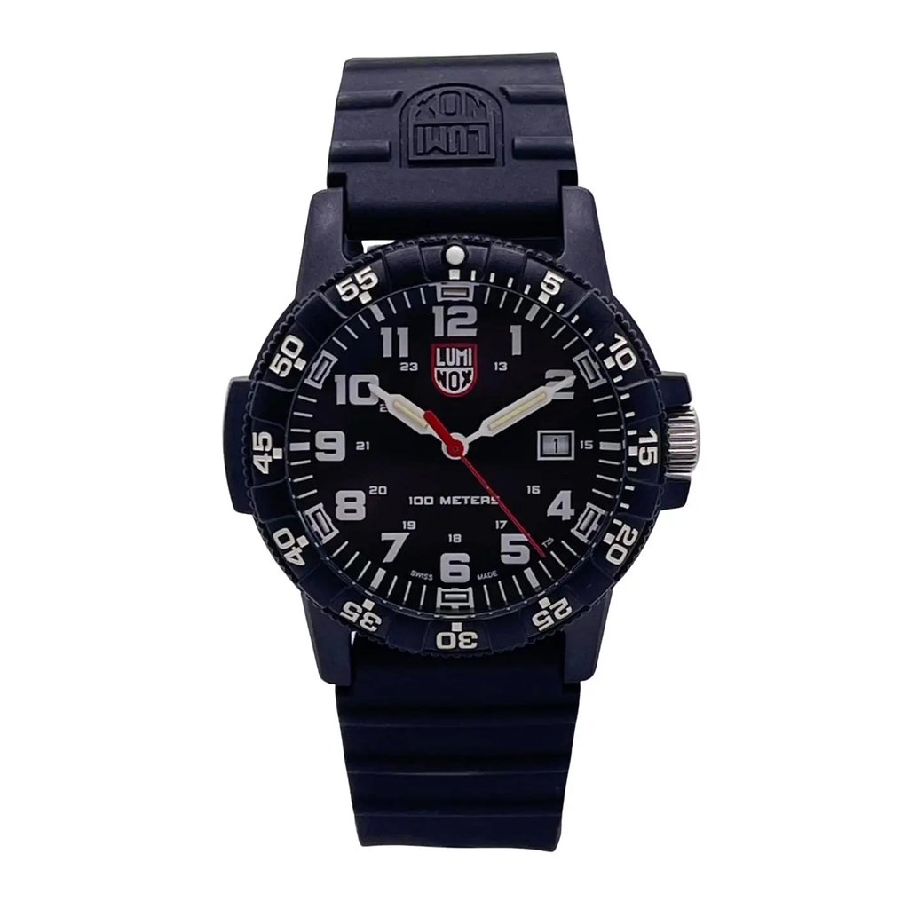An image of a Wristwatch by Luminox. This Pre Owned item is designed for Men, featuring a Casual,Classic,Diver,Military style. It has a Quartz movement and an Analog display with a Black dial color. The indices include 12-Hour Dial,Arabic Numerals,Easy to Read/Large Numerals. The band is made of Rubber and the case is made of Carbon. The watch has a Round shape with a case size of 39 mm and a case thickness of 12 mm.