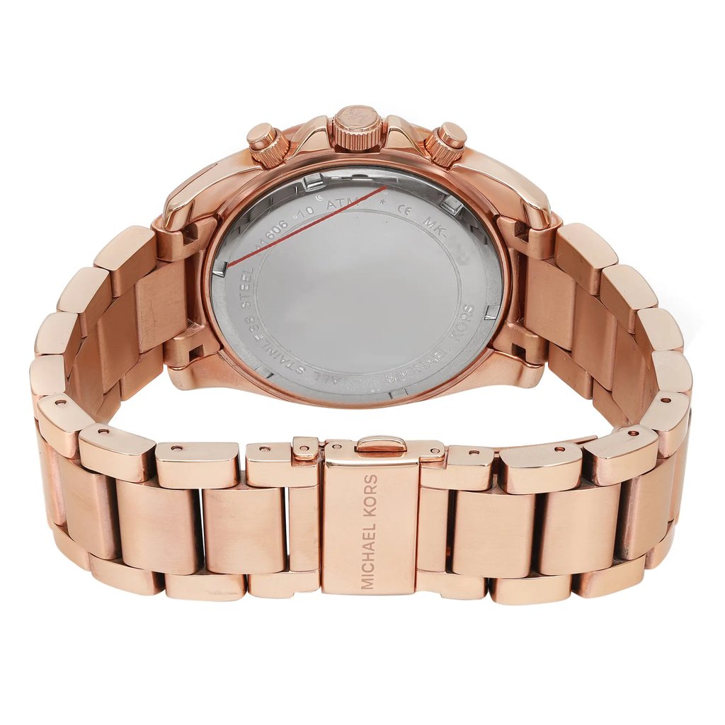 An image of a Wristwatch by Michael Kors. This Pre Owned item is designed for Women, featuring a Casual,Dress/Formal style. It has a Quartz movement and an Analog display with a Rose Gold-Tone dial color. The indices include 12-Hour Dial,Arabic Numerals. The band is made of Stainless Steel and the case is made of Stainless Steel. The watch has a Round shape with a case size of 40 mm and a case thickness of 12 mm.