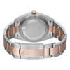 An image of an unworn Rolex men's wristwatch, shown from the back view with a close clasp. The watch has a round case made of stainless steel with a screwback caseback. The band is composed of alternating stainless steel and rose gold links, featuring a fold-over clasp. The perspective is a close-up, focusing on the clasp area with the rest of the watch slightly out of focus, angled to display the design and materials of the band and the backside of the watch case.