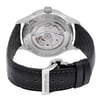 An image of a pre-owned Montblanc men's wristwatch, showcasing the back view with a closed clasp. Positioned at a slight angle, the stainless steel caseback reveals an exhibition design displaying the watch's internal mechanics. The round watch is attached to a black leather band with visible stitching and has a deployant closure. The Montblanc brand name is prominently displayed on the back of the case and on the metal part of the clasp, with a close-up perspective emphasizing the details and craftsmanship.