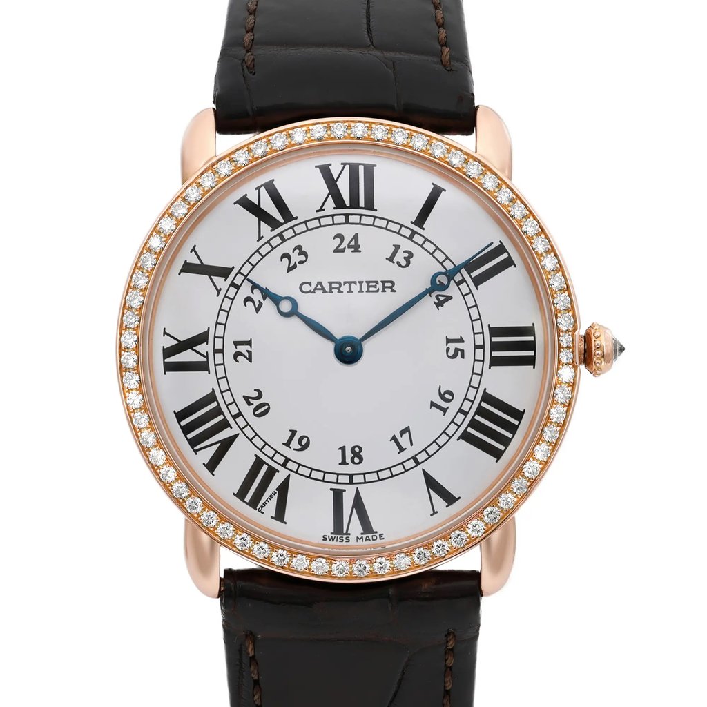 An image of a pre-owned wristwatch taken from a front close-up angle, showcasing the detailed watch face. The watch features a circular design with a diamond-studded bezel. It has a white dial with black Roman numerals and a smaller inner circle with additional hour markings. The hands of the watch are elegantly styled, and the brand name is visible on the dial. The watch has a dark leather strap attached.