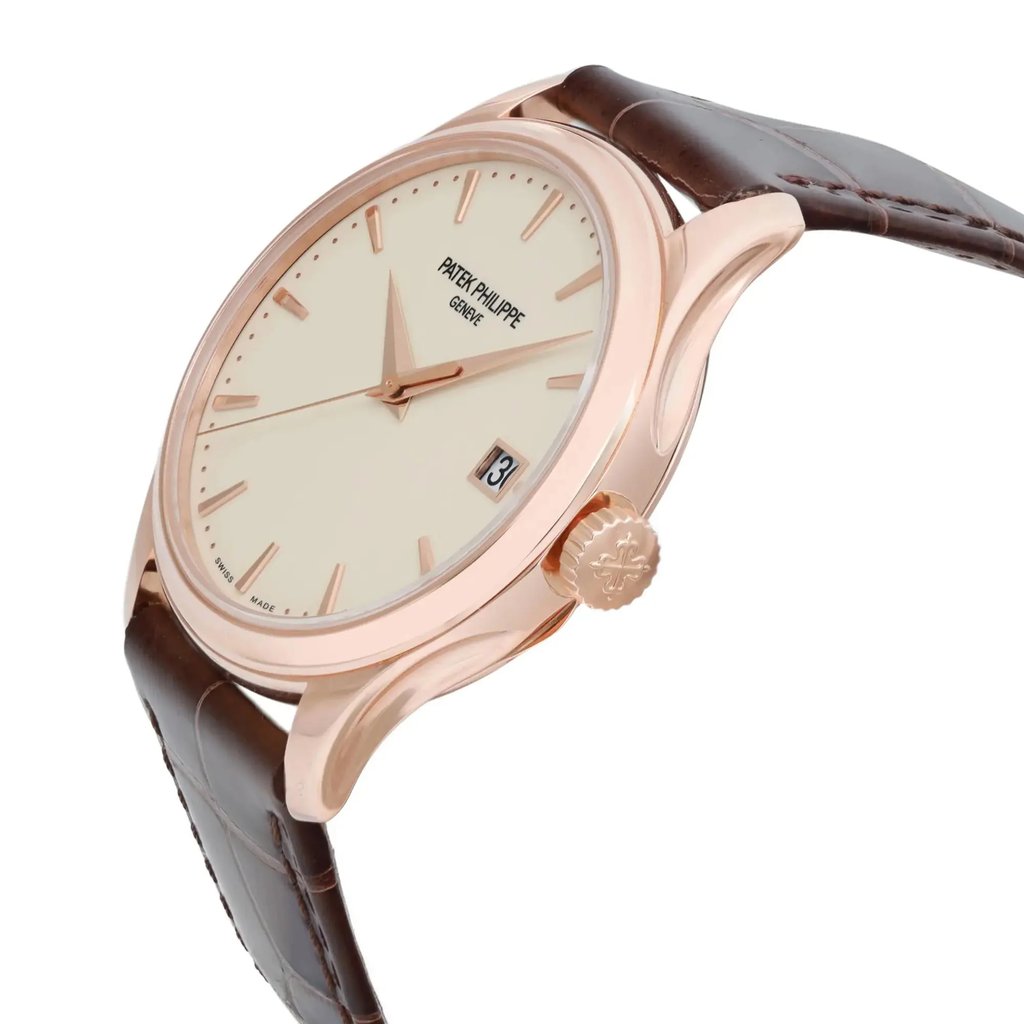 An image of a pre-owned wristwatch shown in a side profile view, focusing on the crown. The watch has a round, gold-toned case with a cream-colored dial and minimalist hour markers. It is positioned at a slight angle, highlighting its elegant design, and is set against a white background. The brown leather strap is partially visible, emphasizing the watch’s luxurious appearance.