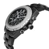 An image of a pre-owned wristwatch shown from a side profile view. The crown is prominently visible on the right side of the watch. The watch features a black band and a round face with a detailed bezel. The image captures the watch at an angle, highlighting its design details and craftsmanship.