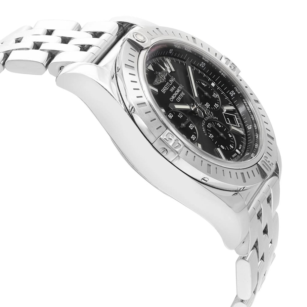 An image of a pre-owned Breitling men's wristwatch in a luxury style, showing a side profile view opposite of the crown. The watch features a round stainless steel case and a stainless steel band. The dial color is gray with a sunburst pattern, and the bezel is also steel-colored. The watch is positioned at an angle that highlights the side contour and part of the watch face, with a medium distance allowing for a detailed view of the timepiece's condition and style. The watch is pre-owned and may have minor scratches and signs of wear.