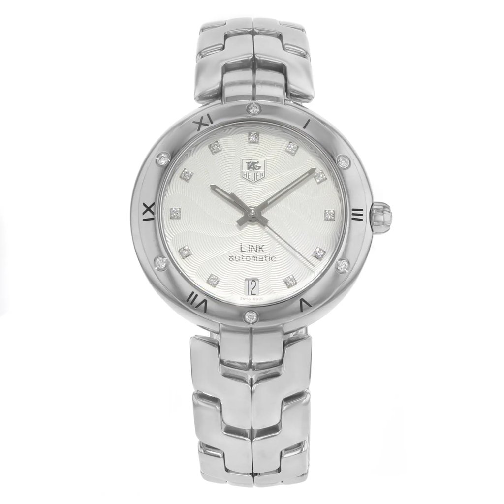 An image of a Wristwatch by TAG Heuer. This Pre Owned item is designed for Women, featuring a Dress/Formal,Luxury style. It has a Mechanical (Automatic) movement and an Analog display with a Silver dial color. The indices include Seconds Hand,Diamonds. The band is made of Stainless Steel and the case is made of Stainless Steel. The watch has a Round shape with a case size of 34 mm and a case thickness of 10 mm.